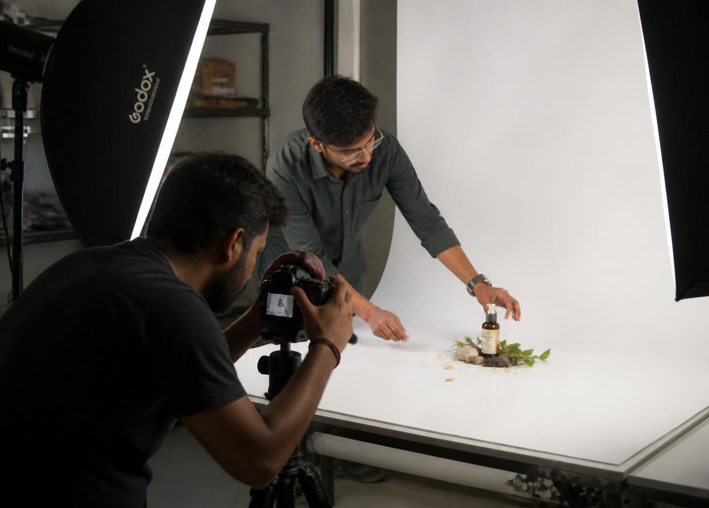 In-house product photography studio setup with packaging, camera and lighting